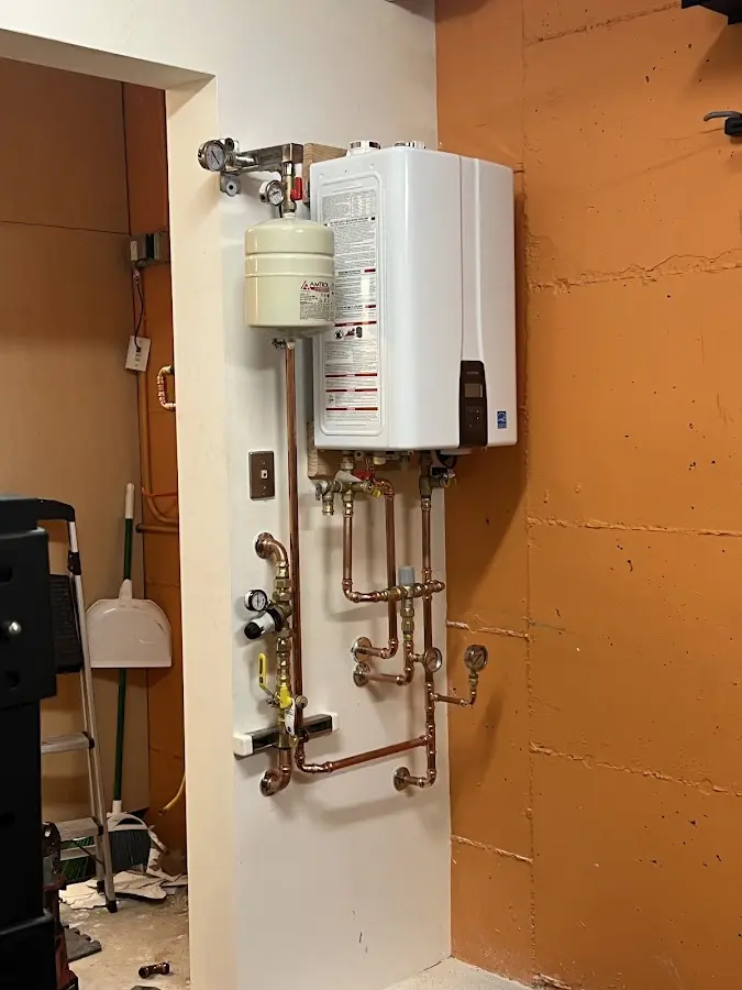 Plumbing technician inspecting water heater connections in Miami Heights